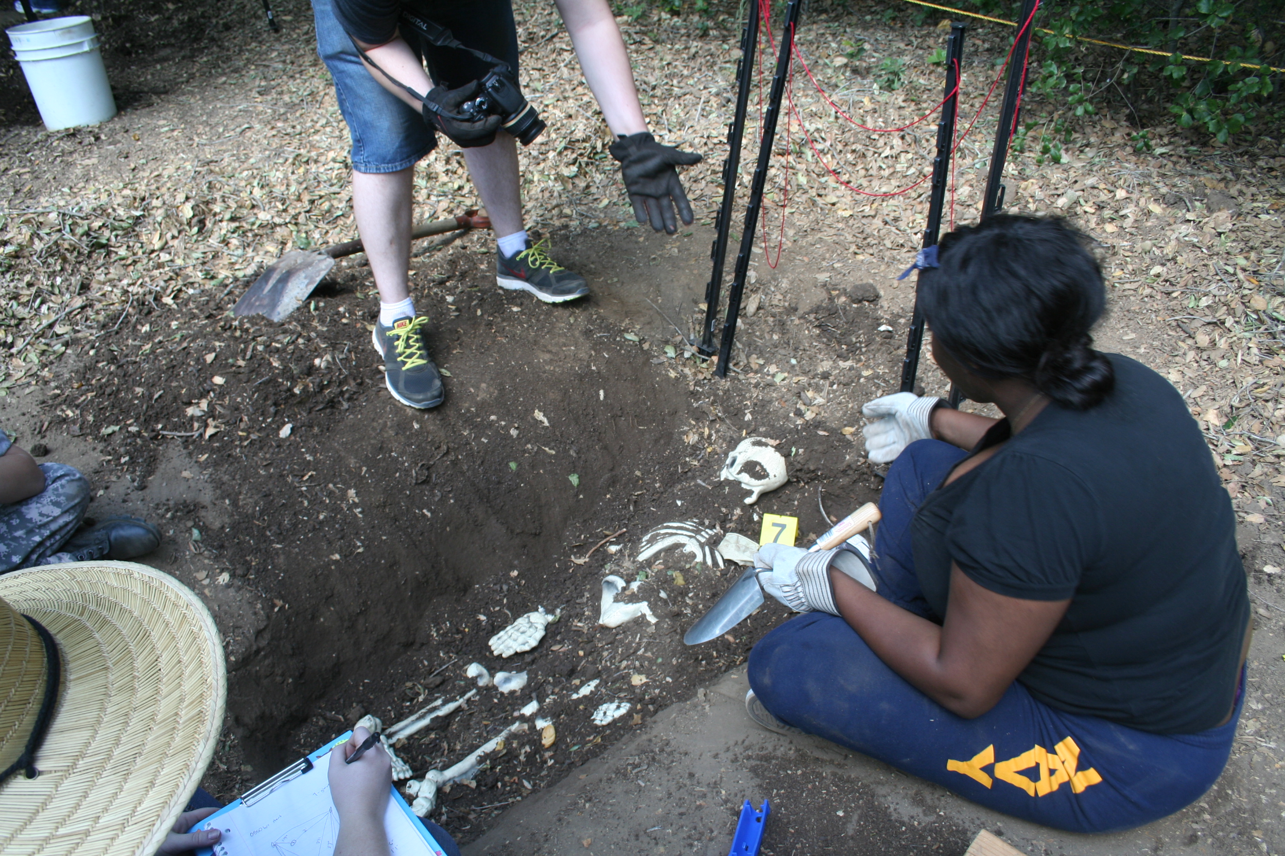 Students at a mock grave dig